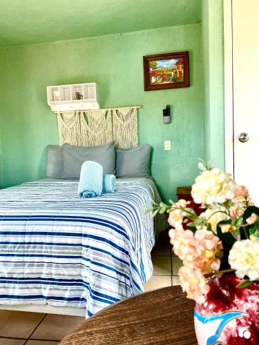 a bedroom with a bed with a blue and white blanket at Casa Rofo in Guanajuato