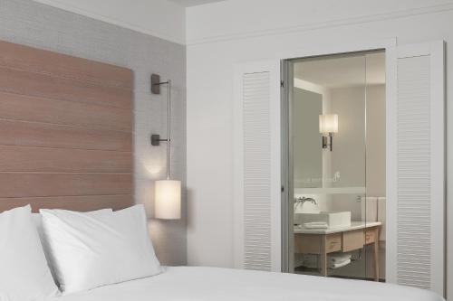 a bedroom with a bed and a sink and a mirror at Doria Hotel Bodrum-City Center in Bitez