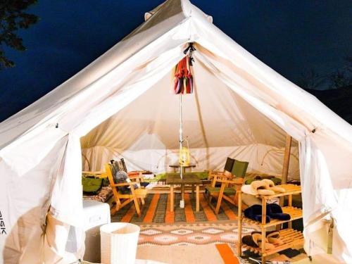 a white tent with a table and chairs in it at Minamiaso STAYHAPPY - Vacation STAY 35418v in Shimoda