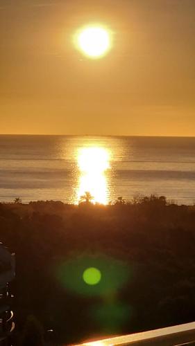a sunset over the ocean with the sun in the sky at Exceptional Apartment in Gran Canet 9th floor with sea view and private garage in Canet de Berenguer