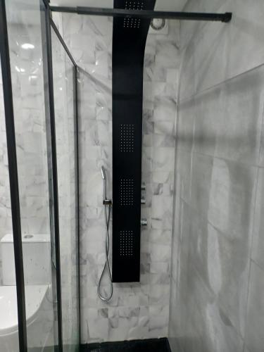 a shower with a black shower head in a bathroom at Oporto Sea Rooms in Porto