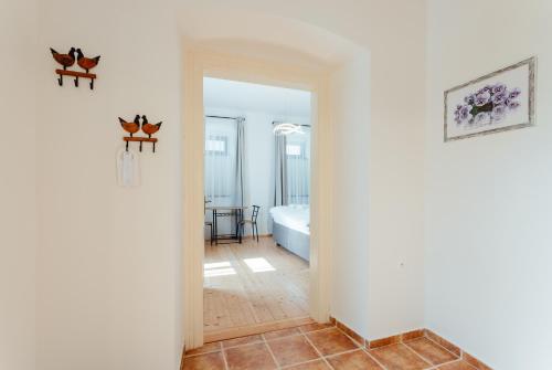 a hallway with a room with a bed at Botanický dvor in Banská Štiavnica