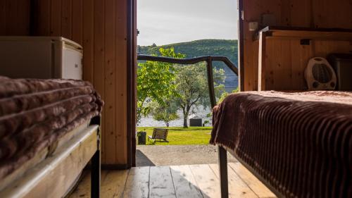 an open door to a room with a bed and a view at Каньон in Hrushivtsi