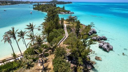 an aerial view of a beach with palm trees and the ocean at Willowbank Resort in Somerset