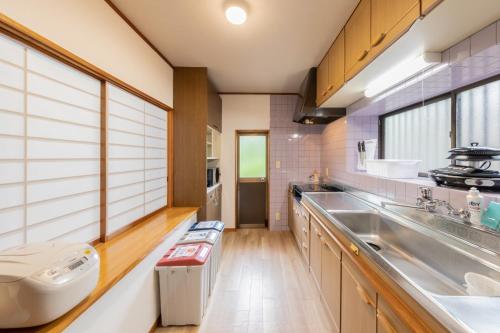 a large kitchen with a sink and a counter at Hot spring inn Nonbiri -Ihatov Nakaizu- - Vacation STAY 51852v in Izu