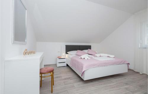 a white bedroom with a pink bed and a chair at Awesome Apartment In Podaca With Kitchen in Podaca
