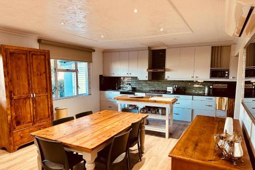 a large kitchen with a wooden table and chairs at Primo farm in Windmeul