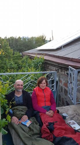 a man and a woman sitting on a porch at B&B Ruzan in Yeghegnadzor