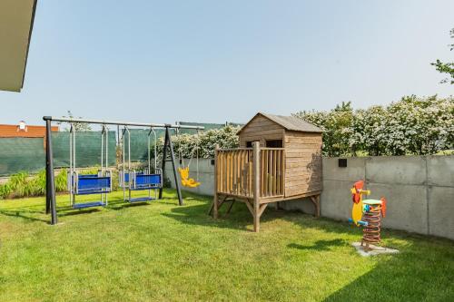 a yard with a playground with a swing at Rybical 42 in Rybical