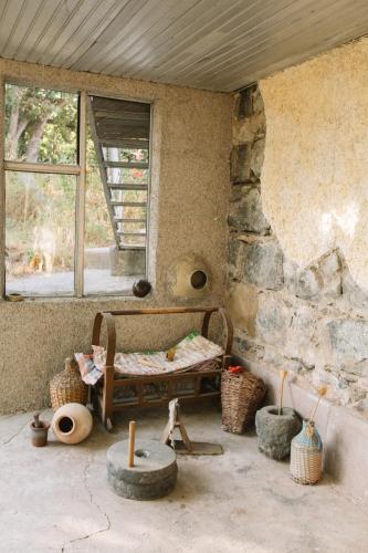 a room with a bed and some baskets and a window at B&B Ruzan in Yeghegnadzor