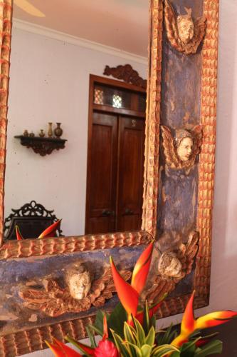 a mirror with a reflection of a door in a room at Hotel Boutique Casa Córdoba Estrella in Cartagena de Indias