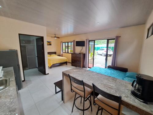 a living room with a table and a bedroom at Casa Uvita Bay in Uvita