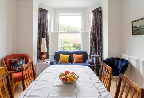 a room with a table with a bowl of fruit on it at Brackenbury House in Portland