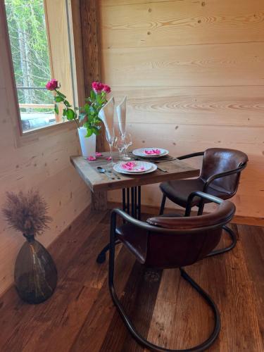 a room with a table and a chair next to a window at Les Écrins du Val de Mouthe, JURA in Petite Chaux