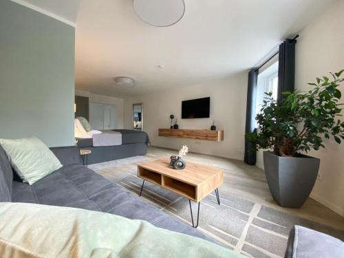 - un salon avec un canapé et une table dans l'établissement QT Apartments Detmold, à Detmold