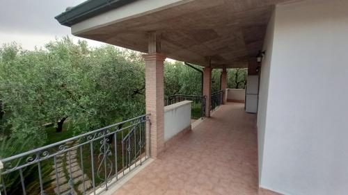 a balcony of a house with a fence and trees at Domus Claudio in Villam in Pomezia