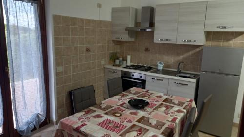 a kitchen with a table with a table cloth on it at Domus Claudio in Villam in Pomezia