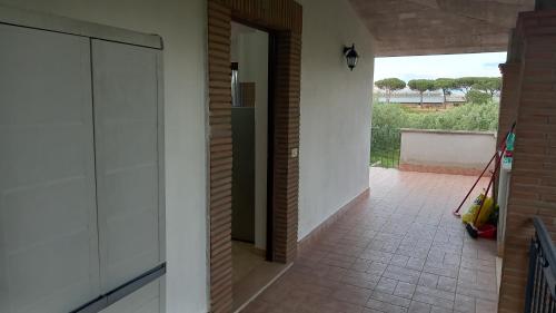 a hallway of a house with an open door at Domus Claudio in Villam in Pomezia