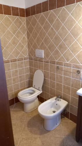 a bathroom with a toilet and a sink at Domus Claudio in Villam in Pomezia
