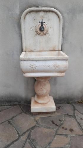a white toilet sitting on a stone floor at Domus Claudio in Villam in Pomezia