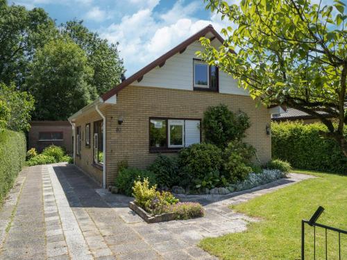 a brick house with a driveway at Holiday Home Zeeland near Westerschelde in Baarland