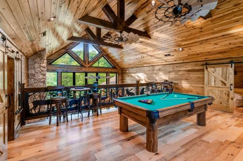 a pool table in a room with wooden ceilings at Enchanting Riverscape in Townsend