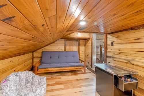 a room with a blue couch in a wooden room at Enchanting Riverscape in Townsend