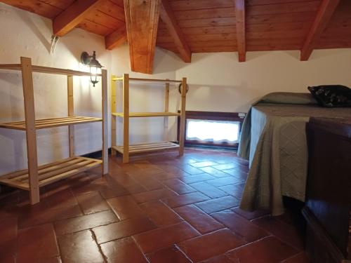 a bedroom with a bed and a tiled floor at Il Fontolo in Ponzano Superiore