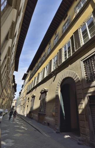 a building with an archway on the side of a street at Palazzo Guicciardini in Florence
