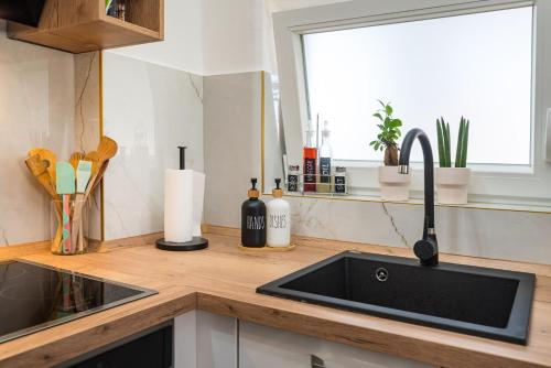 a kitchen counter with a sink and a window at Apartment MAVI in Zadar