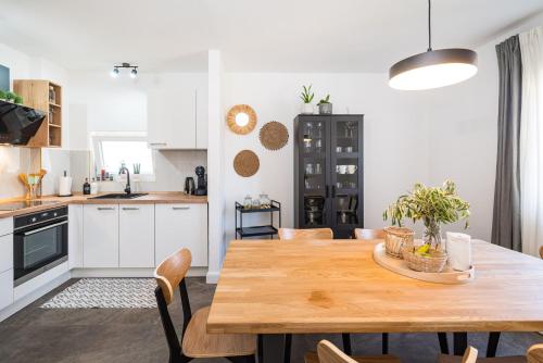 a kitchen and dining room with a wooden table and chairs at Apartment MAVI in Zadar