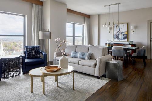 a living room with a couch and a table at Lancaster Marriott at Penn Square in Lancaster