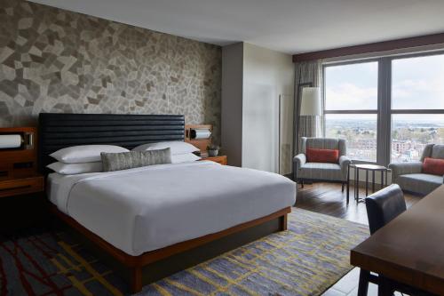 a hotel room with a large bed and a desk at Lancaster Marriott at Penn Square in Lancaster
