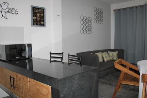 a kitchen and living room with a table and a couch at Centrico Depto (101) in Cancún