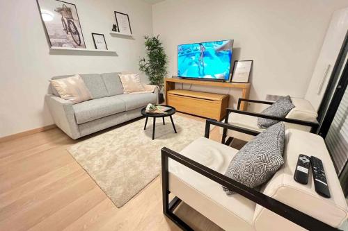 a living room with a couch and a tv at Very quiet apartment with balcony in Saint-Denis