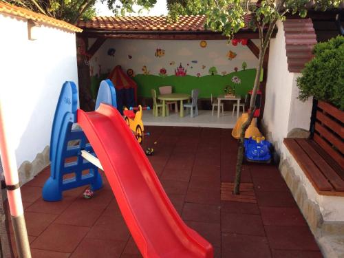 a childrens playground with a slide and a table at Family Hotel Accent in Razgrad