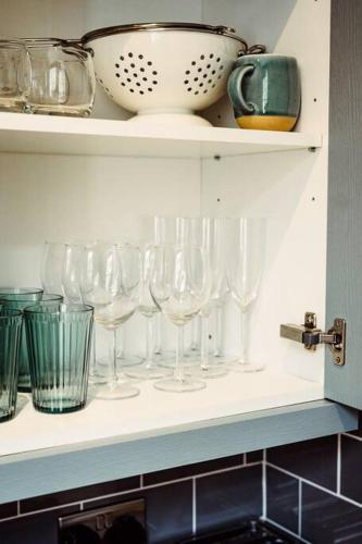 a row of wine glasses sitting on a shelf at Artistic hideaway within York’s ancient city walls in York