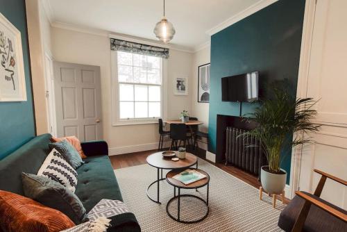 a living room with a couch and a table at Artistic hideaway within York’s ancient city walls in York