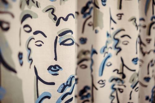 a group of curtains with faces painted on them at Artistic hideaway within York’s ancient city walls in York