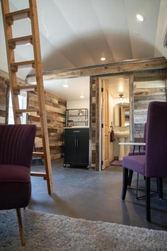 a room with a ladder and a table and chairs at The Huckleberry A Teton Tiny Home in Driggs