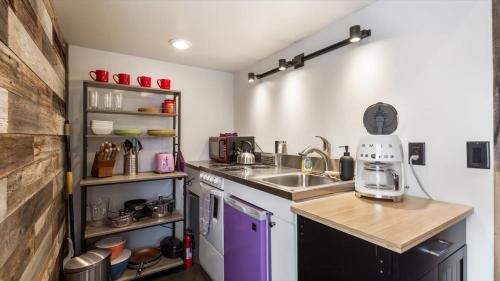 a small kitchen with a sink and a counter at The Huckleberry A Teton Tiny Home in Driggs