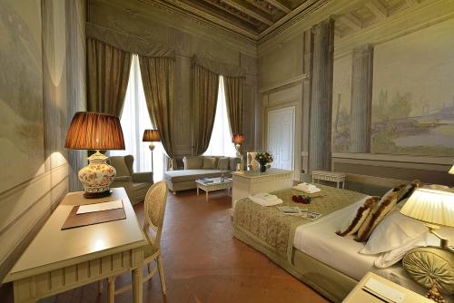 a living room filled with furniture and a large window at Palazzo Guicciardini in Florence