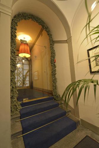a hallway with blue carpeted stairs in a building at Palazzo Guicciardini in Florence