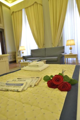 a room with a table with roses on it at Palazzo Guicciardini in Florence