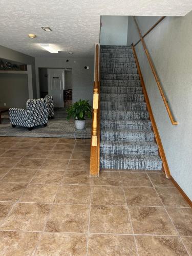 a staircase in a room with a tile floor at Platte Valley Inn in Columbus