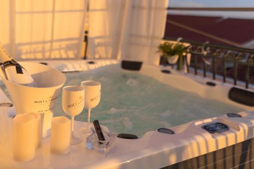 a bath tub with a hot tub with a hot tub at Apartment Mozart in Šibenik