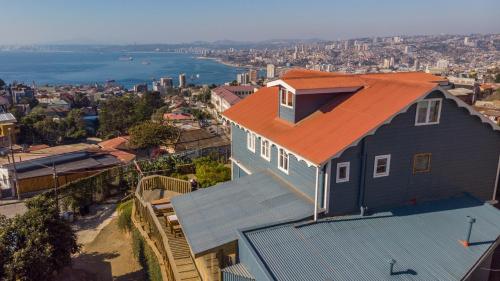 a house with an orange roof on top of it at Hotel Faro Azul Valparaíso Cerro Alegre in Valparaíso