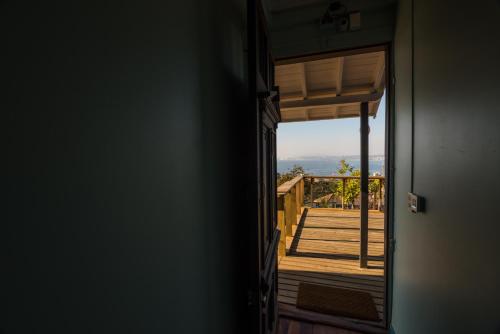 a door to a porch with a view of a deck at Hotel Faro Azul Valparaíso Cerro Alegre in Valparaíso