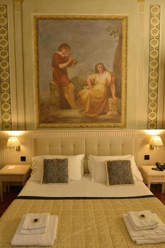 a bedroom with a painting on the wall and a bed at Palazzo Guicciardini in Florence