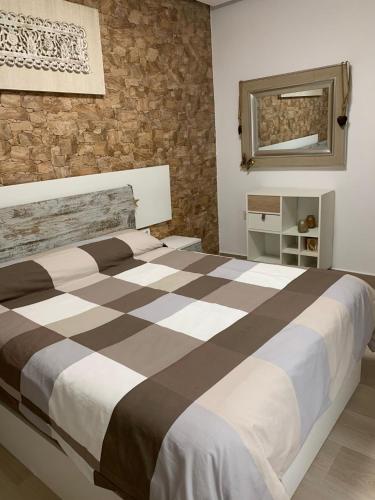 a bedroom with a large bed with a checkerboard pattern at CASA CONFORT in Grao de Castellón